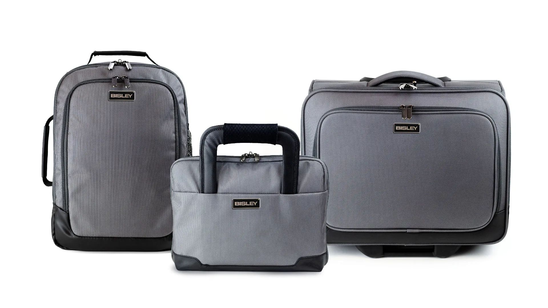 The three products together on white: the day-sack, the messenger style laptop case and the wheeled trolley case, all in grey ballistic nylon with a black Bisley badge.
